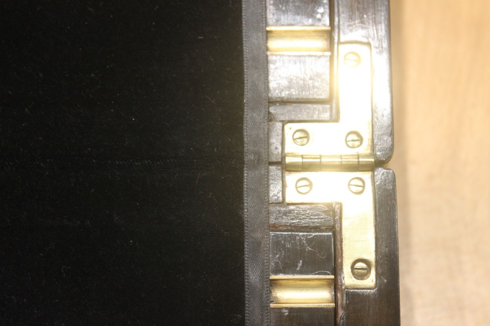 A rectangular Victorian burr walnut writing slope featuring a brass cartouche on top and a brass escutcheon with key on the front. View XIII