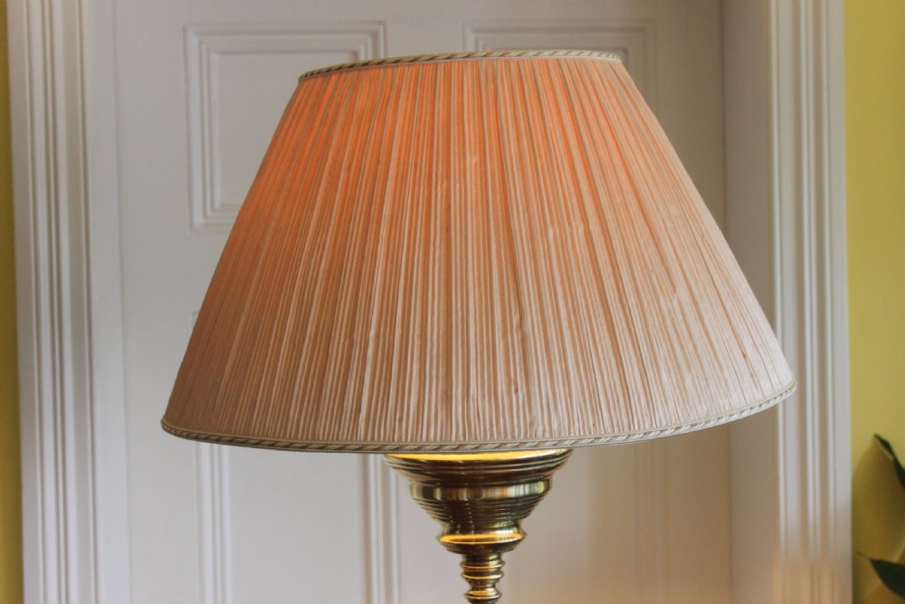 A tall Victorian brass telescopic standard lamp featuring a reeded column, gadrooned base, and a pleated fabric lampshade. View III