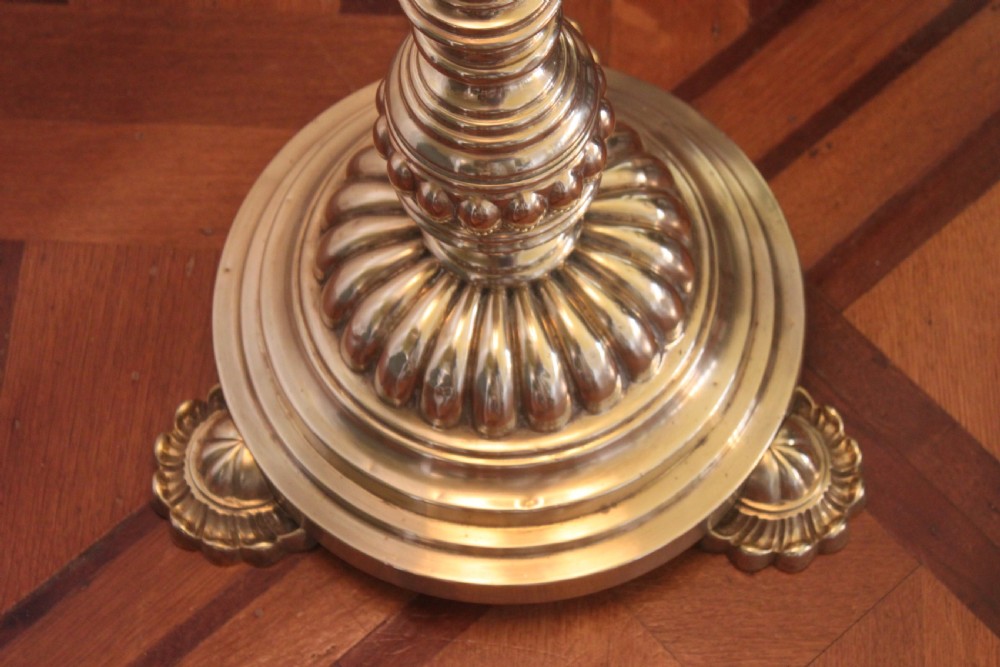 A tall Victorian brass telescopic standard lamp featuring a reeded column, gadrooned base, and a pleated fabric lampshade. View VI