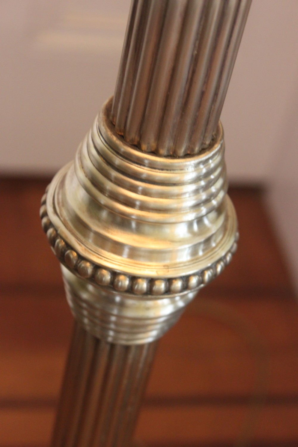 A tall Victorian brass telescopic standard lamp featuring a reeded column, gadrooned base, and a pleated fabric lampshade. View VII