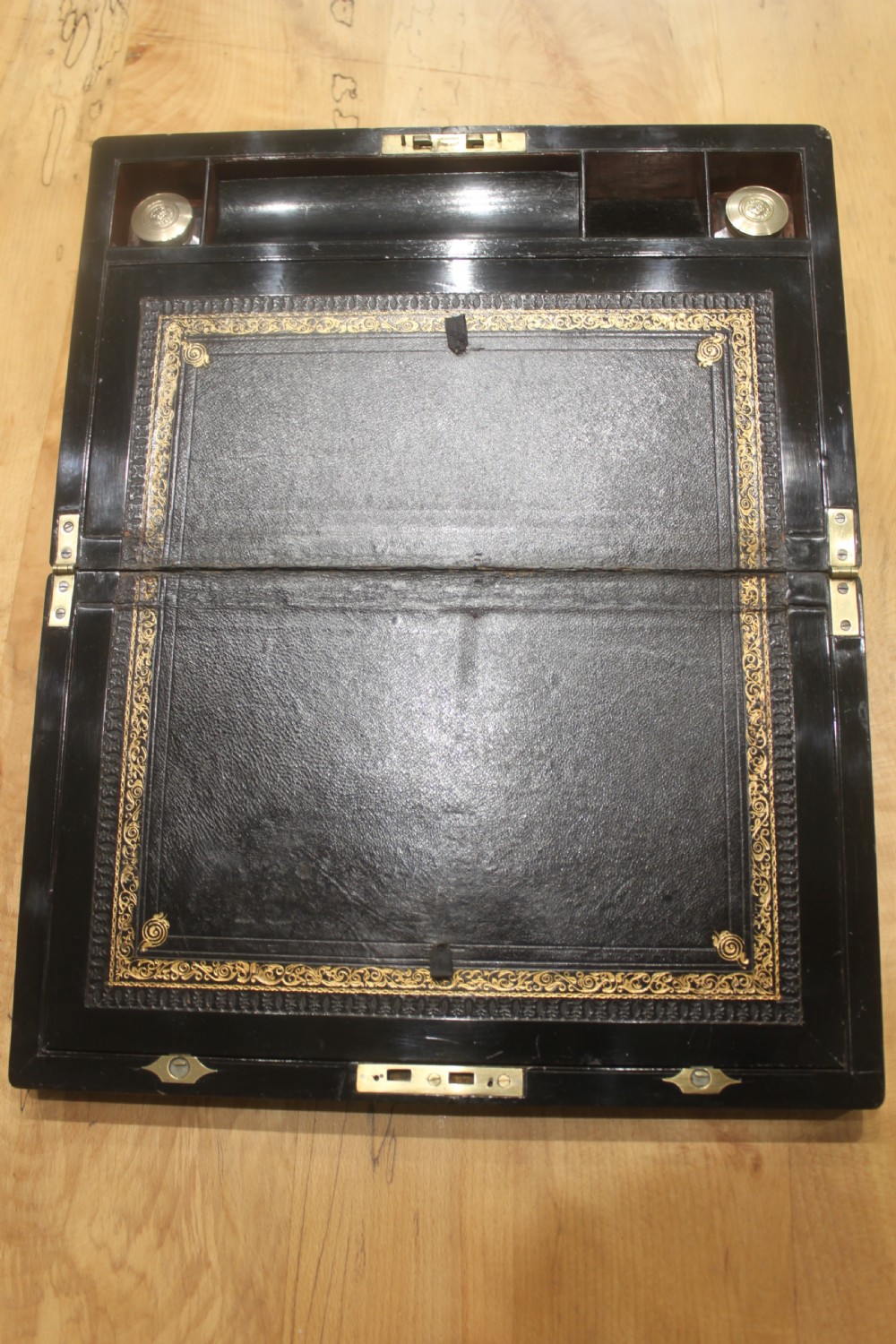 A rectangular antique burr walnut writing slope with an inlaid central cartouche and a brass circular Bramah lock on the front face. View VII