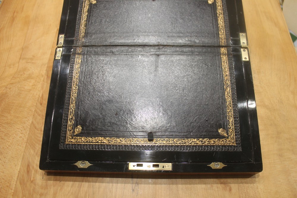 A rectangular antique burr walnut writing slope with an inlaid central cartouche and a brass circular Bramah lock on the front face. View VIII