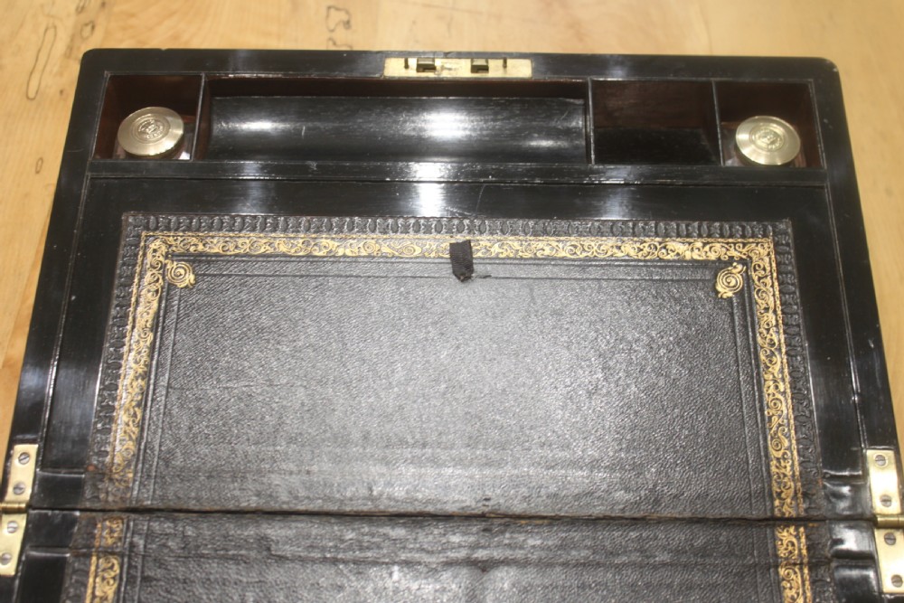 A rectangular antique burr walnut writing slope with an inlaid central cartouche and a brass circular Bramah lock on the front face. View IX