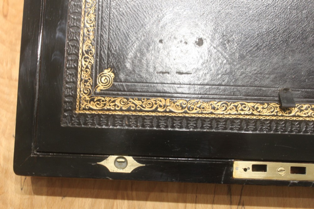 A rectangular antique burr walnut writing slope with an inlaid central cartouche and a brass circular Bramah lock on the front face. View X
