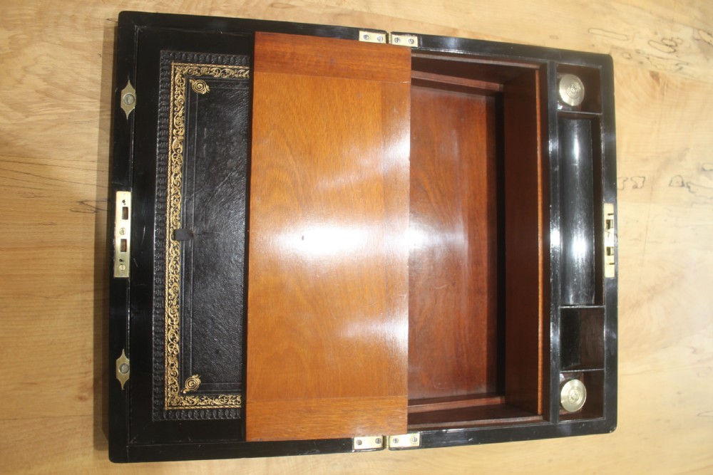 A rectangular antique burr walnut writing slope with an inlaid central cartouche and a brass circular Bramah lock on the front face. View XII