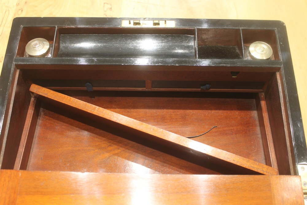 A rectangular antique burr walnut writing slope with an inlaid central cartouche and a brass circular Bramah lock on the front face. View XIV
