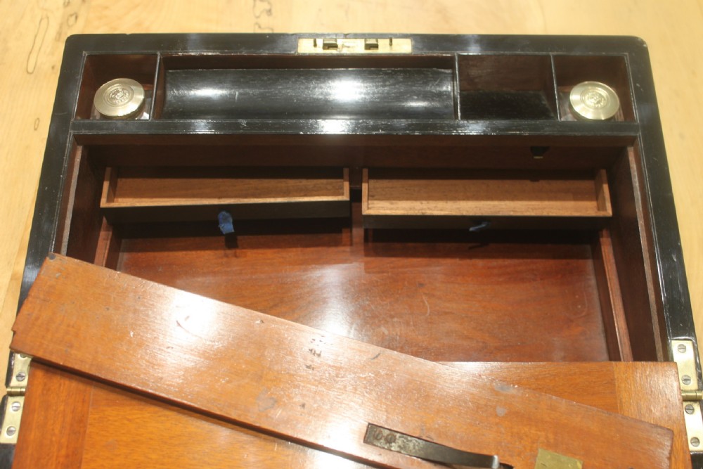 A rectangular antique burr walnut writing slope with an inlaid central cartouche and a brass circular Bramah lock on the front face. View XV