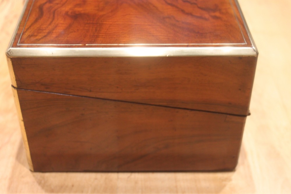 A rectangular dark walnut box featuring brass corner edging, an inlaid brass cartouche on the lid, and a brass escutcheon with a key and tassel. View IV
