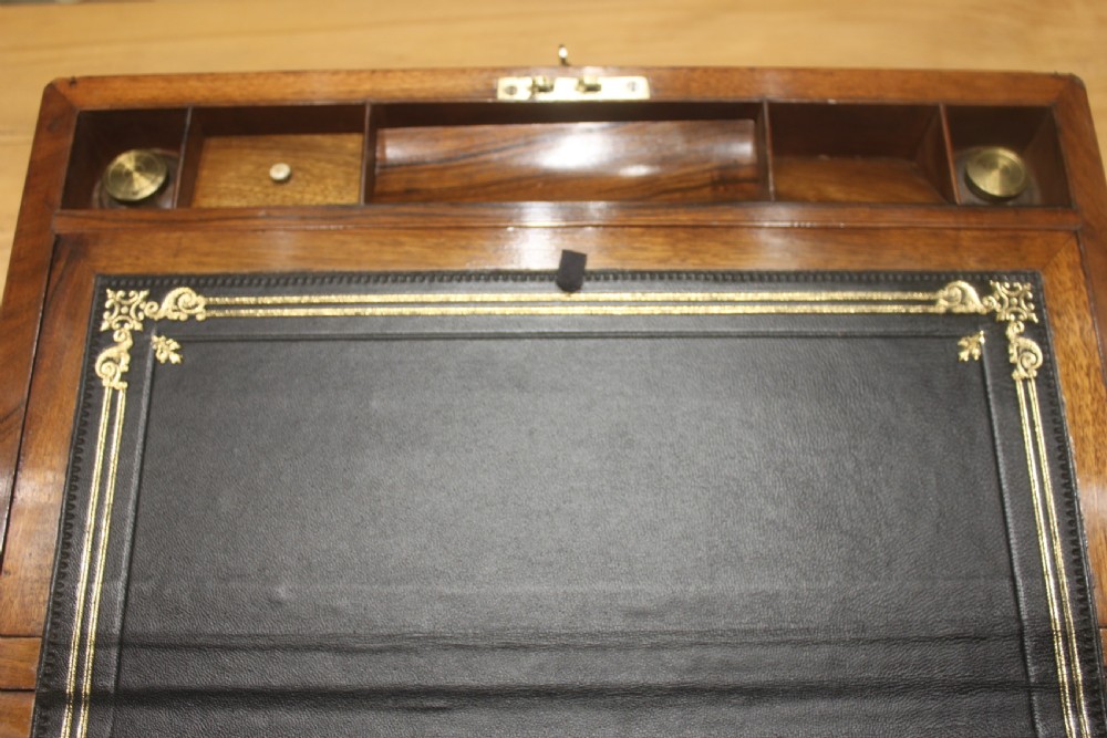 A rectangular dark walnut box featuring brass corner edging, an inlaid brass cartouche on the lid, and a brass escutcheon with a key and tassel. View IX