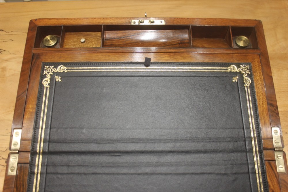 A rectangular dark walnut box featuring brass corner edging, an inlaid brass cartouche on the lid, and a brass escutcheon with a key and tassel. View XI