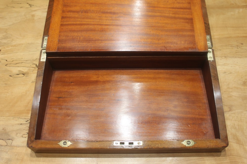 A rectangular dark walnut box featuring brass corner edging, an inlaid brass cartouche on the lid, and a brass escutcheon with a key and tassel. View XII