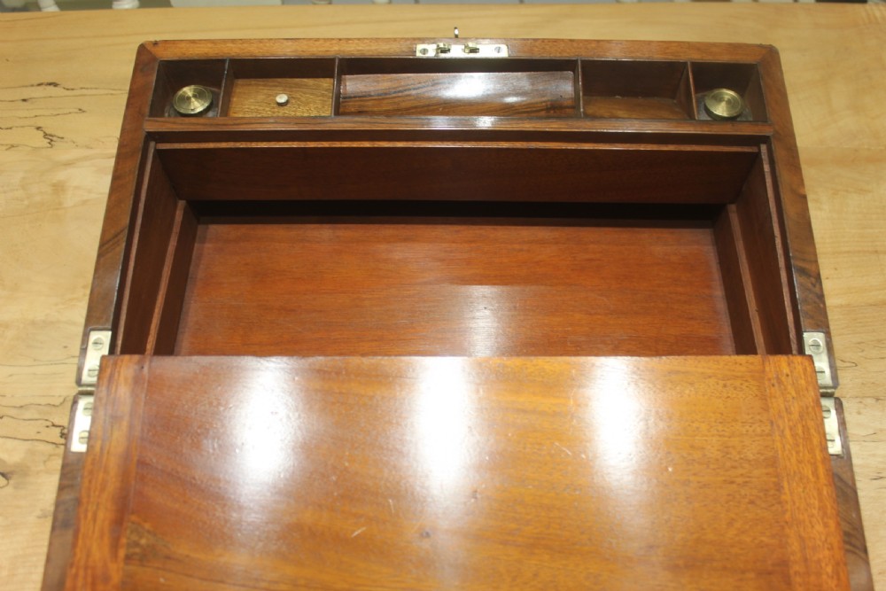 A rectangular dark walnut box featuring brass corner edging, an inlaid brass cartouche on the lid, and a brass escutcheon with a key and tassel. View XIII