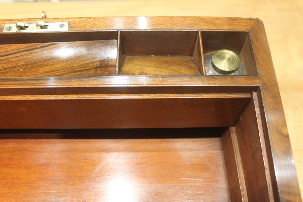 A rectangular dark walnut box featuring brass corner edging, an inlaid brass cartouche on the lid, and a brass escutcheon with a key and tassel. View XV