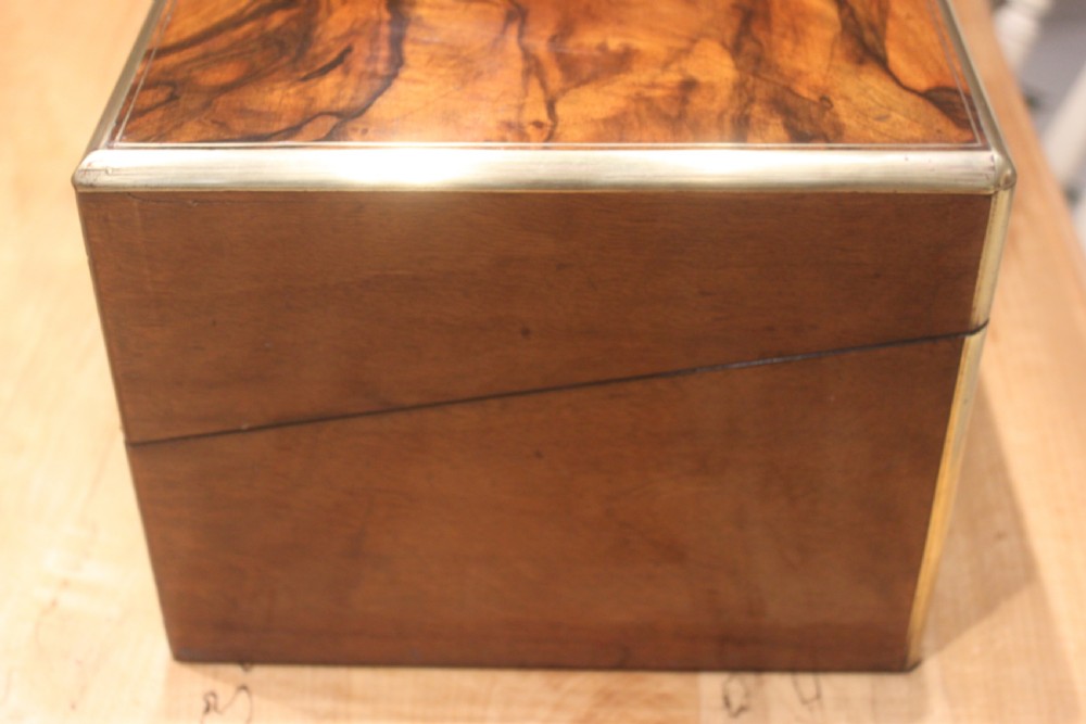A rectangular Victorian writing slope crafted from figured walnut with brass binding, a top brass cartouche, and a brass key escutcheon with a tassel. View III