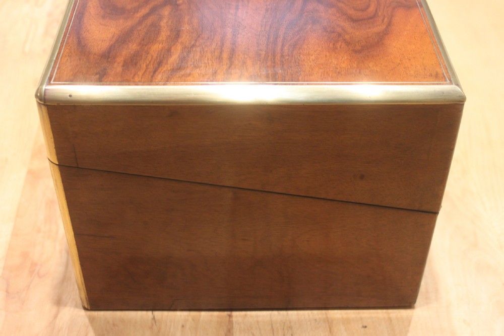 A rectangular Victorian writing slope crafted from figured walnut with brass binding, a top brass cartouche, and a brass key escutcheon with a tassel. View V
