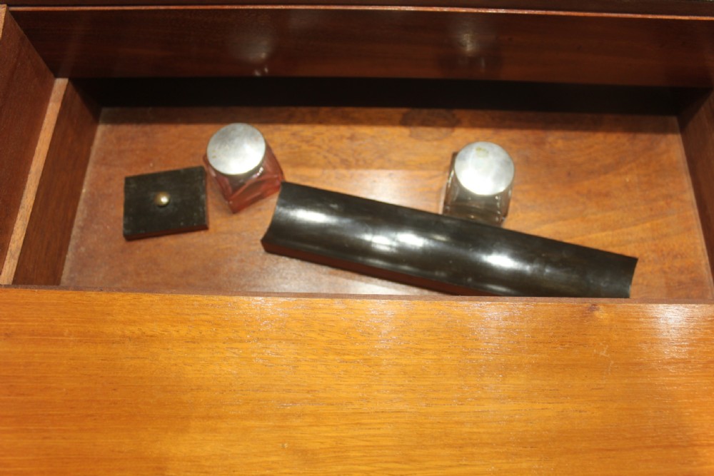 A rectangular Victorian writing slope crafted from figured walnut with brass binding, a top brass cartouche, and a brass key escutcheon with a tassel. View XII