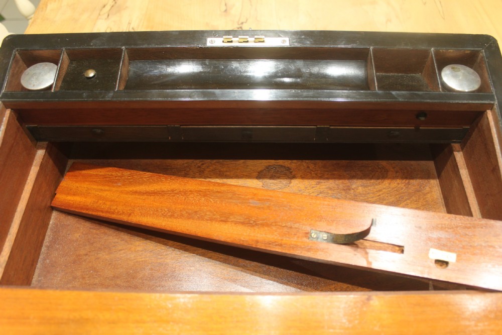 A rectangular Victorian writing slope crafted from figured walnut with brass binding, a top brass cartouche, and a brass key escutcheon with a tassel. View XIII
