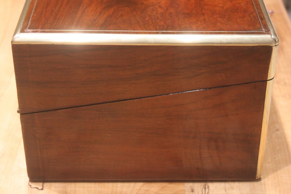 A dark walnut rectangular writing slope with brass edge binding, an inset brass plaque on top, and a brass escutcheon with key. View II