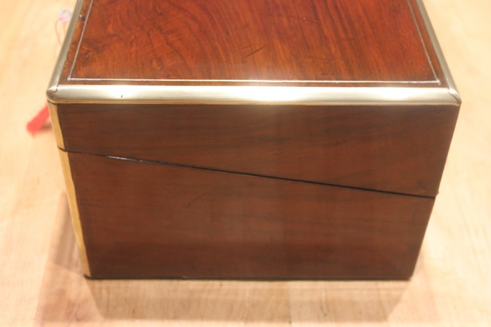 A dark walnut rectangular writing slope with brass edge binding, an inset brass plaque on top, and a brass escutcheon with key. View IV