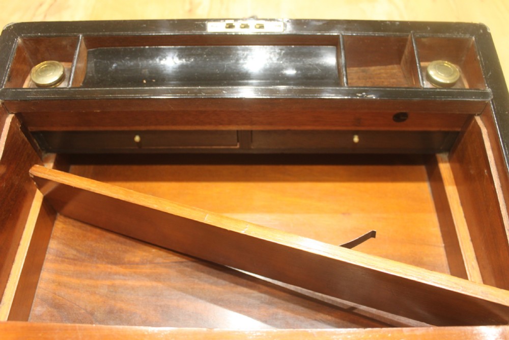 A dark walnut rectangular writing slope with brass edge binding, an inset brass plaque on top, and a brass escutcheon with key. View XI