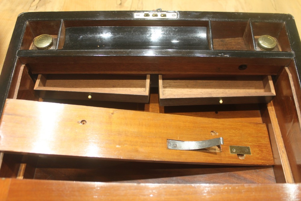 A dark walnut rectangular writing slope with brass edge binding, an inset brass plaque on top, and a brass escutcheon with key. View XII