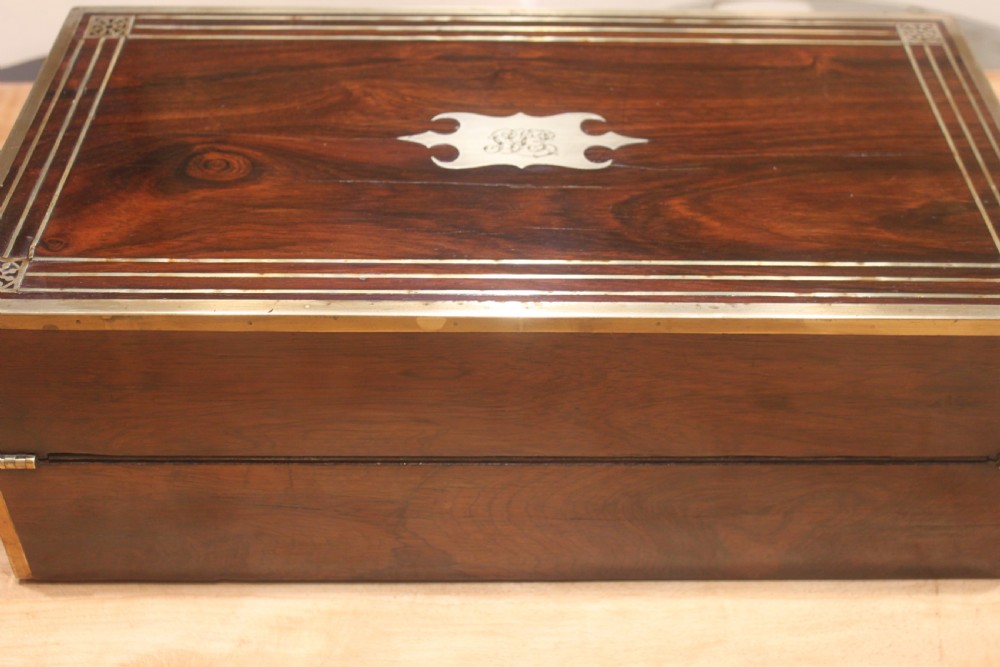 A late Georgian dark rosewood writing slope box decorated with geometric brass stringing, corner details, and a central brass cartouche. View III