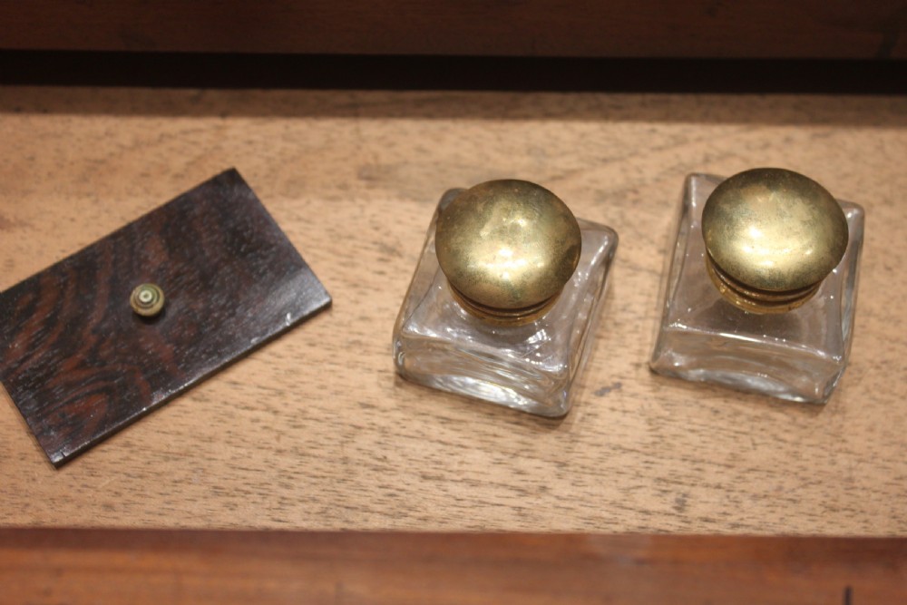 A late Georgian dark rosewood writing slope box decorated with geometric brass stringing, corner details, and a central brass cartouche. View XI