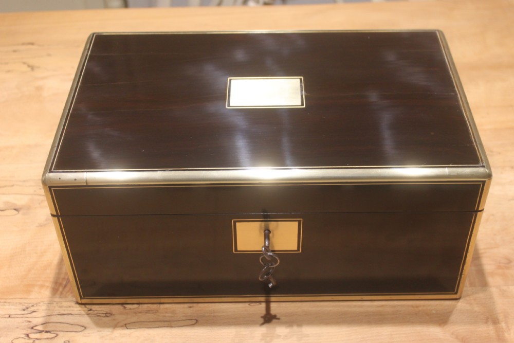 A quality late 19th century Coromandel and brass bound writing slope