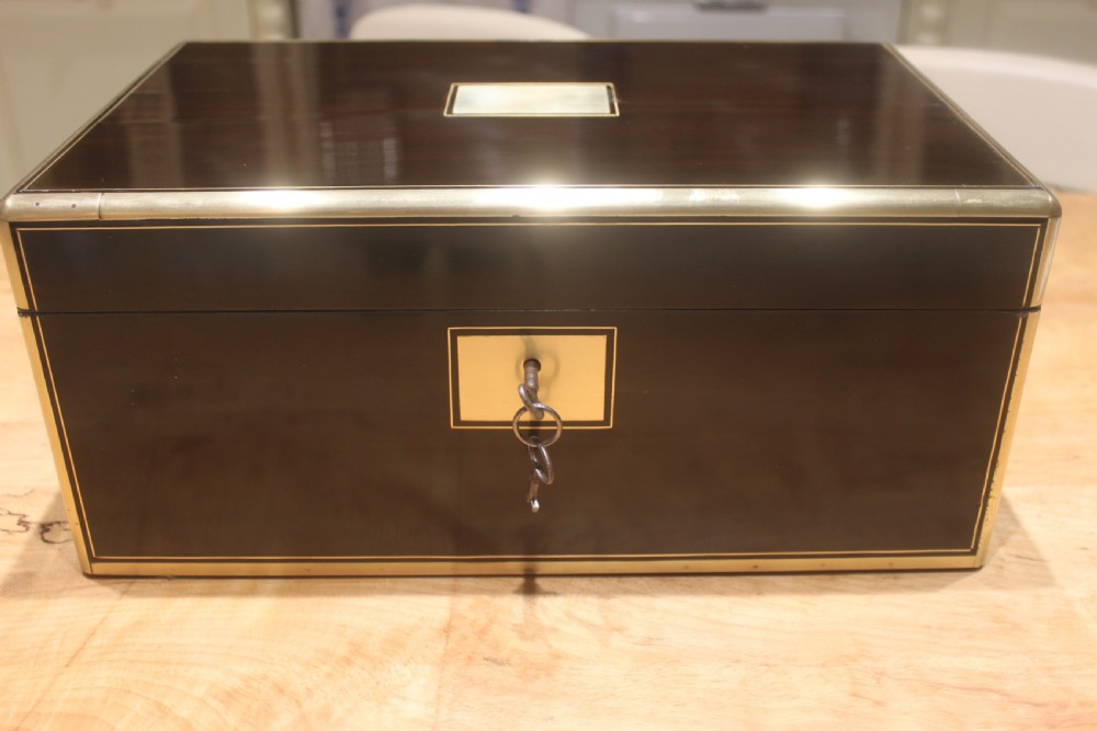 A quality late 19th century Coromandel and brass bound writing slope View V