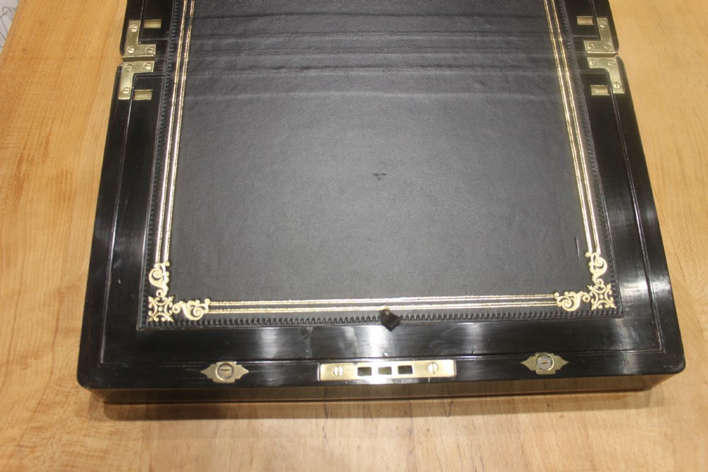 A quality late 19th century Coromandel and brass bound writing slope View VII