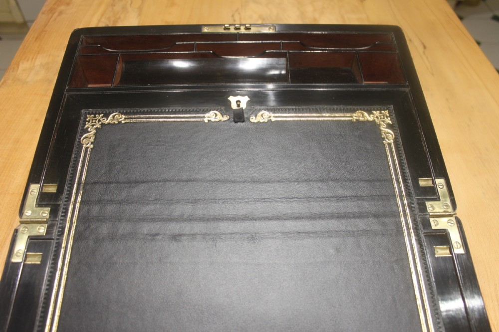 A quality late 19th century Coromandel and brass bound writing slope View VIII