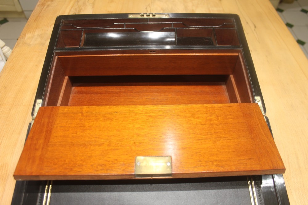 A quality late 19th century Coromandel and brass bound writing slope View XII