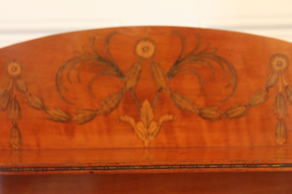 An antique Sheraton style satinwood cabinet with an open tiered shelving top unit and a lower two-door cabinet featuring oval inlaid marquetry panels. View IV