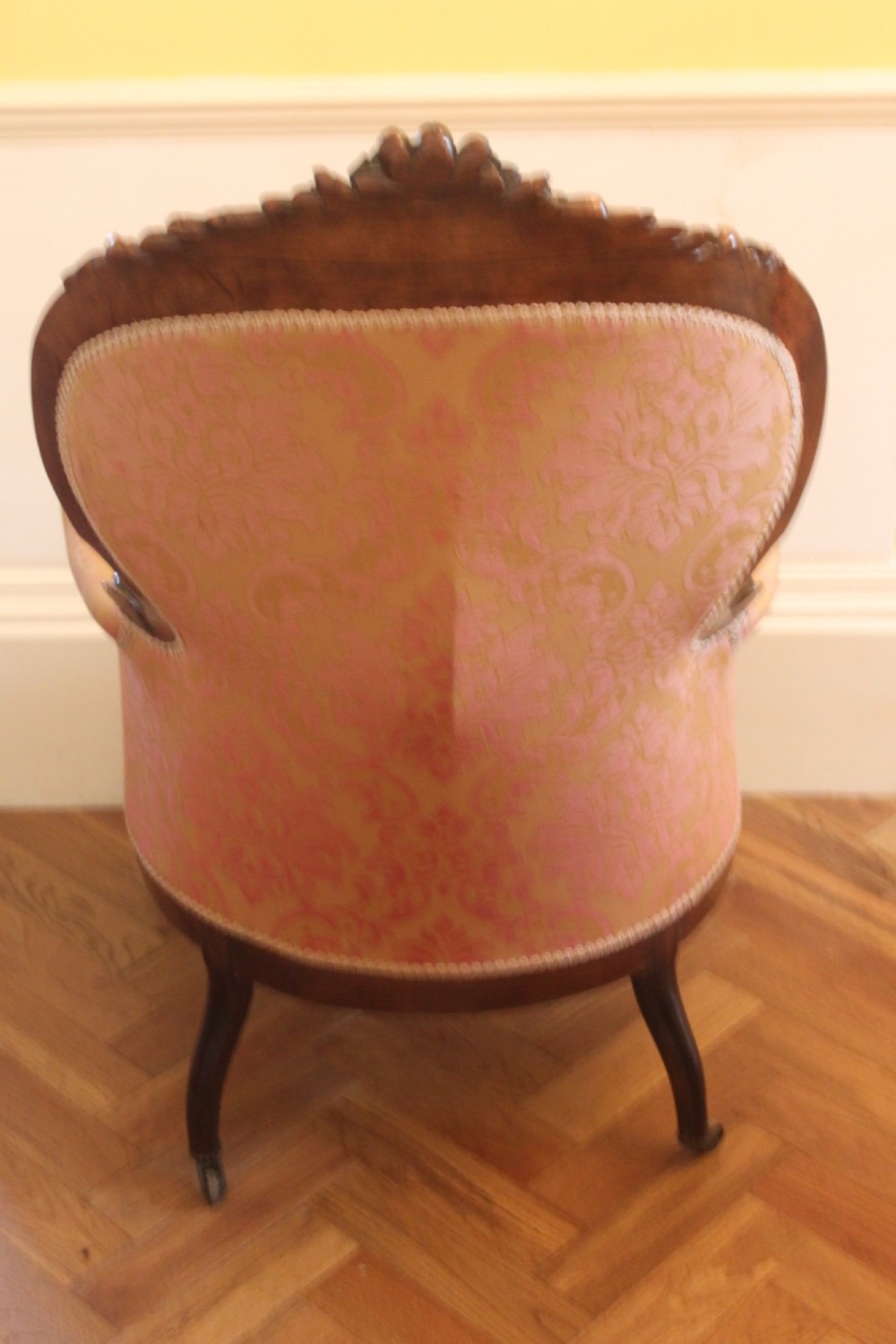 An early Victorian balloon-back gentlemans armchair with a carved dark mahogany frame, button-backed yellow damask upholstery, and cabriole legs. View III