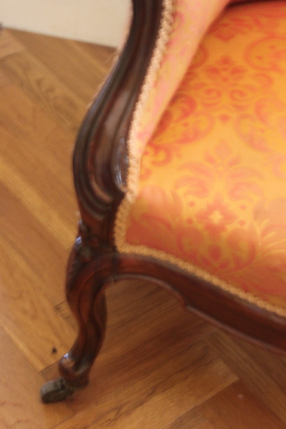 An early Victorian balloon-back gentlemans armchair with a carved dark mahogany frame, button-backed yellow damask upholstery, and cabriole legs. View VIII