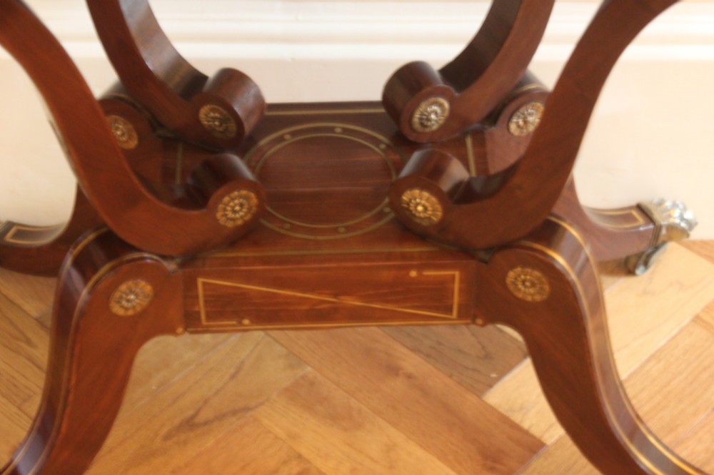A Regency mahogany fold-over card table featuring geometric brass inlay, scroll supports, and brass paw feet on castors. View IV