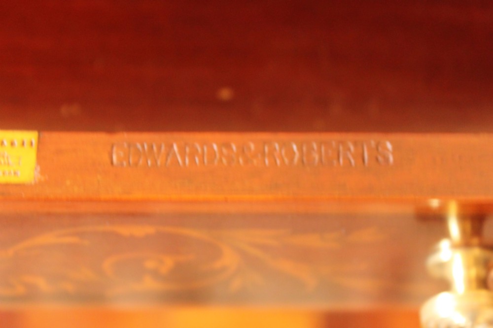 A Sheraton Revival mahogany writing desk featuring intricate marquetry inlays, a brown leather writing surface, a raised superstructure with small drawers, and square tapered legs. View VI