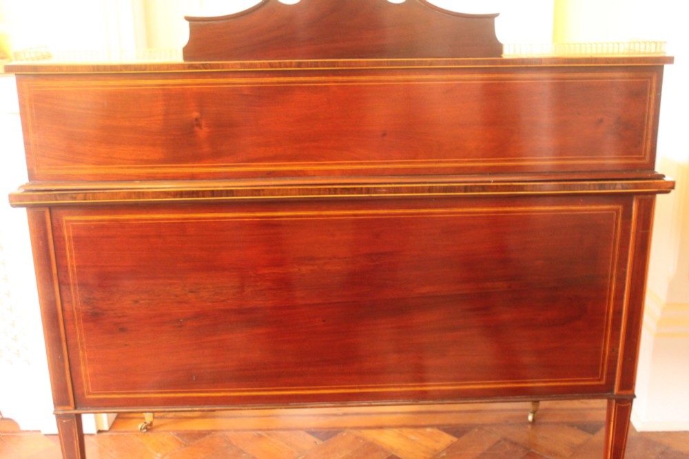 A Sheraton Revival mahogany writing desk featuring intricate marquetry inlays, a brown leather writing surface, a raised superstructure with small drawers, and square tapered legs. View XIII
