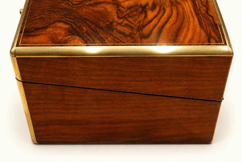 A rectangular Victorian rosewood writing slope featuring brass-bound edges, an inlaid central brass plaque, and a key with a tassel in a brass Bramah lock. View IV