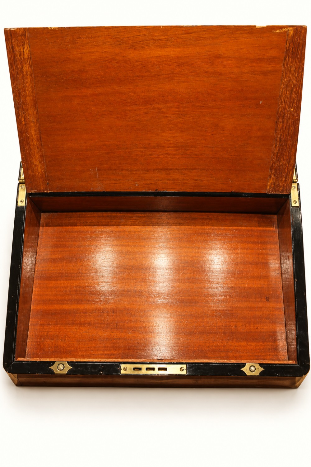 A rectangular Victorian walnut writing slope box featuring polished brass edge binding, a central brass inlaid plaque, and a key inserted into the front lock. View VIII