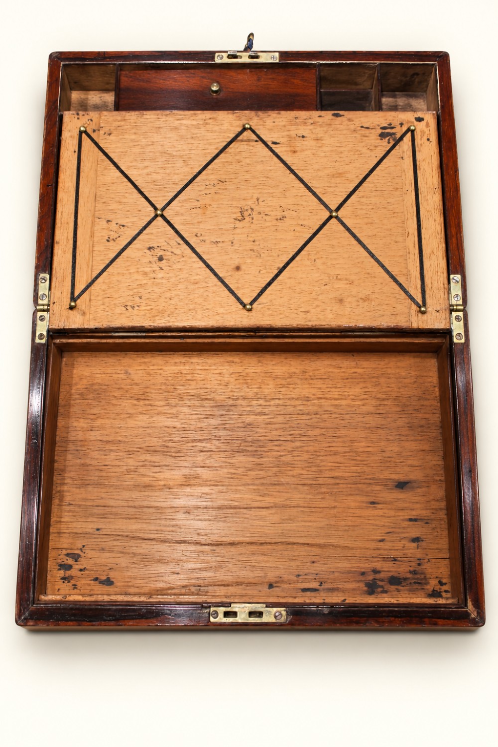 A rectangular dark rosewood wooden writing slope featuring double brass stringing inlay, a central brass cartouche, and an escutcheon with an inserted key. View VII