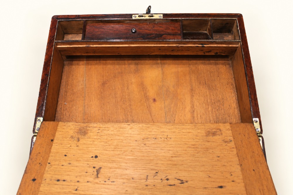 A rectangular dark rosewood wooden writing slope featuring double brass stringing inlay, a central brass cartouche, and an escutcheon with an inserted key. View VIII