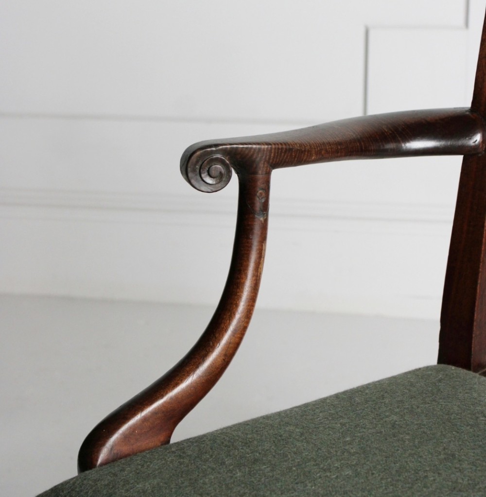 A Georgian dark mahogany open armchair featuring a pierced lattice back splat, curved arms, and a green upholstered seat. View II