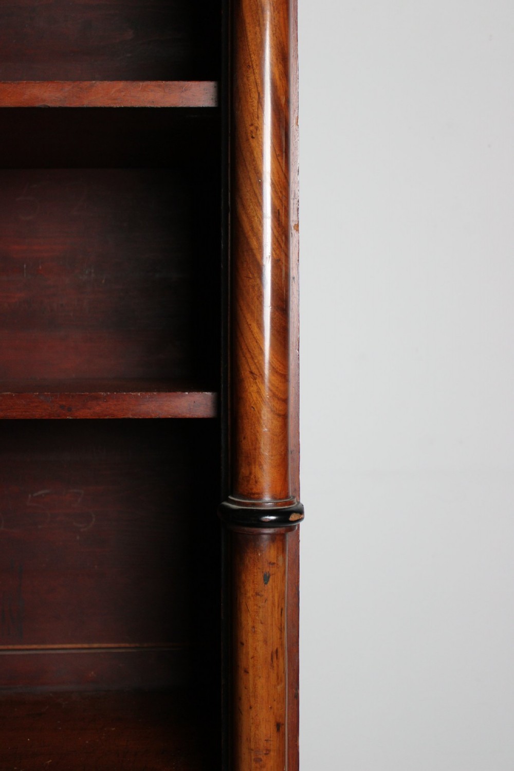 A large 19th-century double-bay open timber bookcase with arched tops and turned column pilasters in a warm brown finish. View II