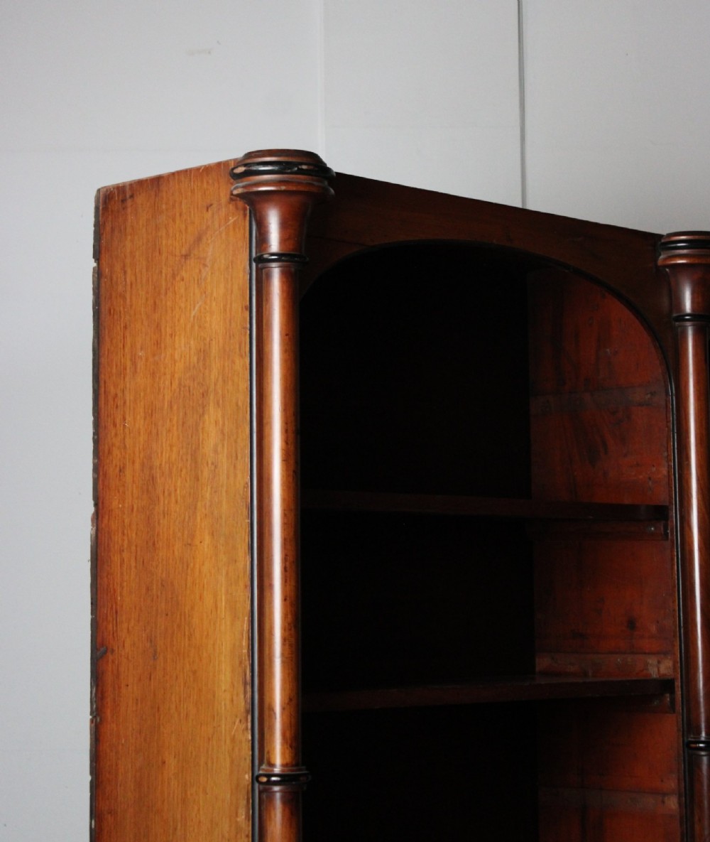 A large 19th-century double-bay open timber bookcase with arched tops and turned column pilasters in a warm brown finish. View III
