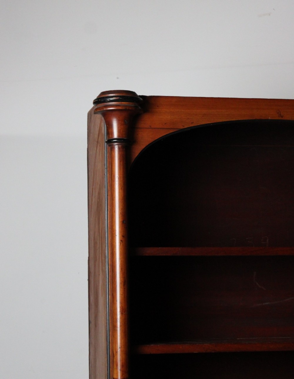 A large 19th-century double-bay open timber bookcase with arched tops and turned column pilasters in a warm brown finish. View IV