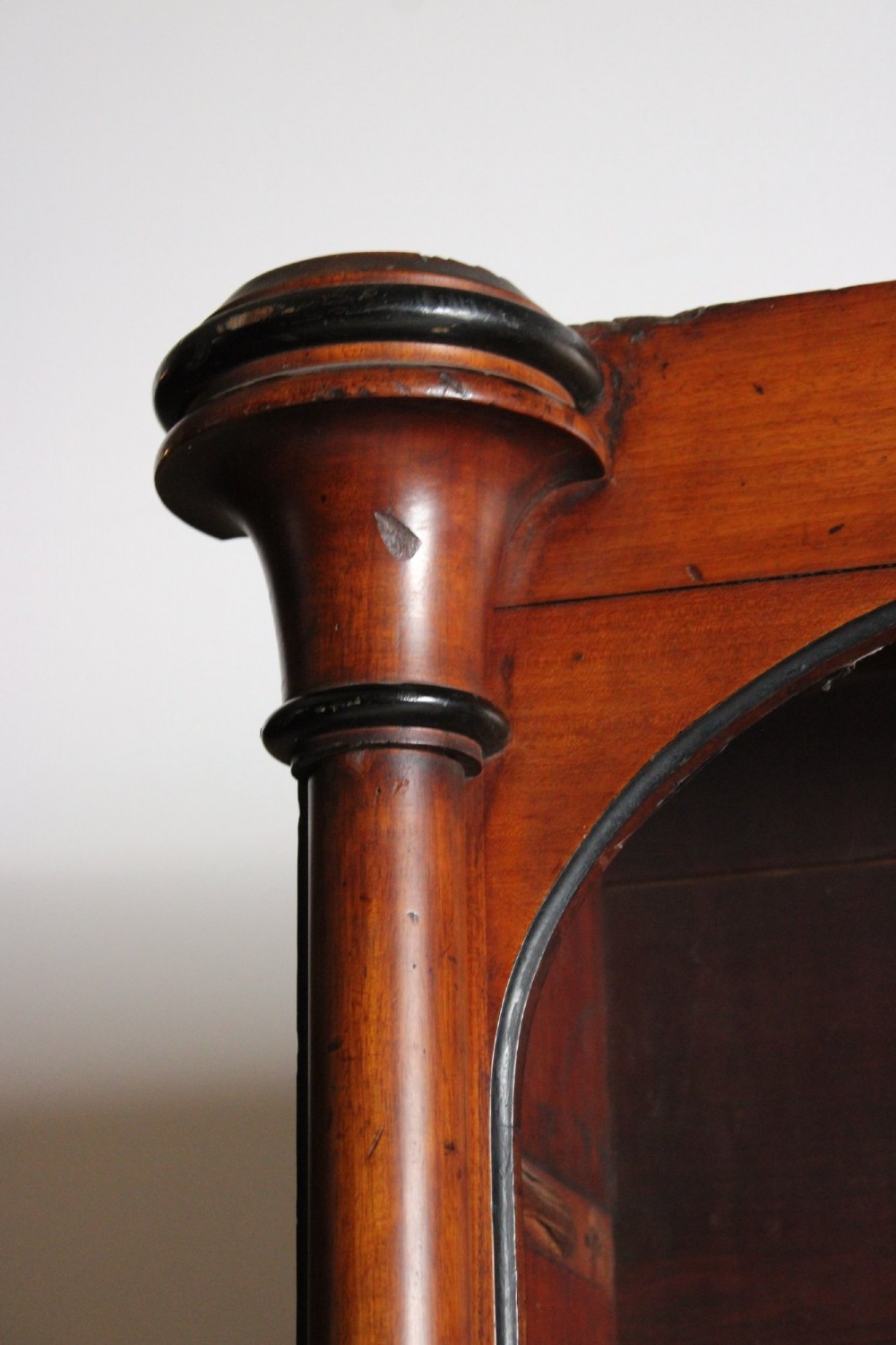 A large 19th-century double-bay open timber bookcase with arched tops and turned column pilasters in a warm brown finish. View VII
