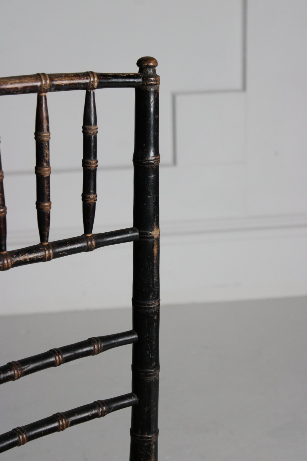 A late 19th-century ebonised side chair featuring turned faux bamboo detailing and a woven rush seat. View IV