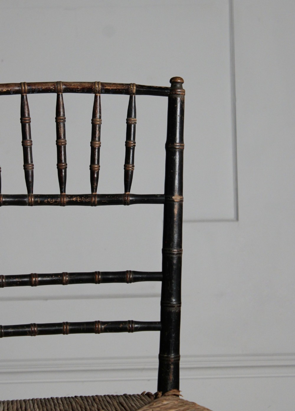 A late 19th-century ebonised side chair featuring turned faux bamboo detailing and a woven rush seat. View VIII