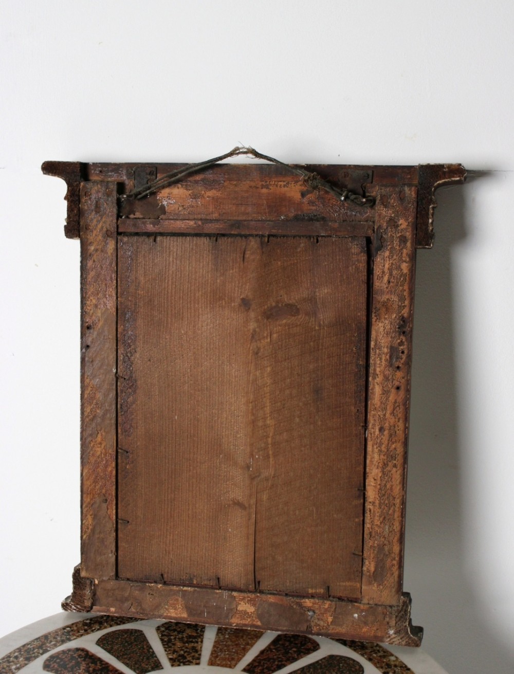 An early 19th century Regency giltwood pier mirror with reeded pilaster sides, a stepped architectural cornice, and foxed glass mirror plate. View VI